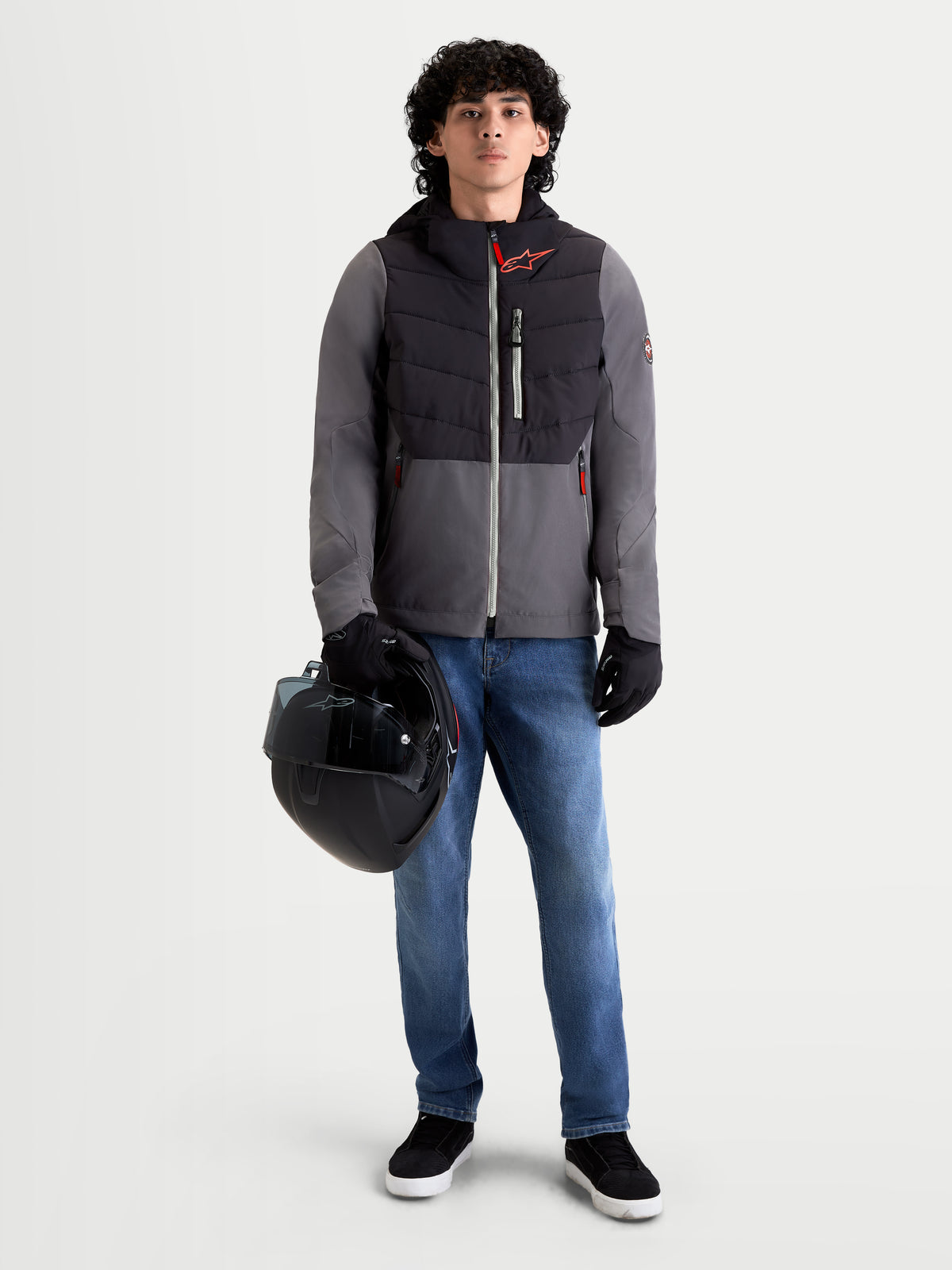 Alpinestars Therma-Tech Waterproof Jacket, men's urban contemporary motorcycle jacket in black and dark gray, front view on a model wearing jeans, gloves, and holding a helmet