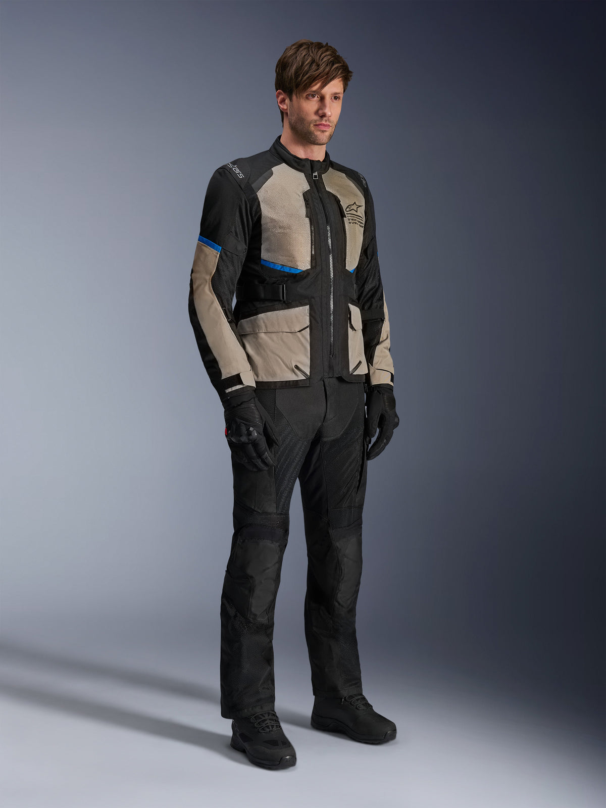 Alpinestars Andes Air Drystar® Jacket, Motorcycle Touring Jacket, Black Laurel Gray and Bright Blue, worn with matching riding pants and gloves, featuring extensive mesh panels for airflow and a road-oriented fit, adventure touring gear
