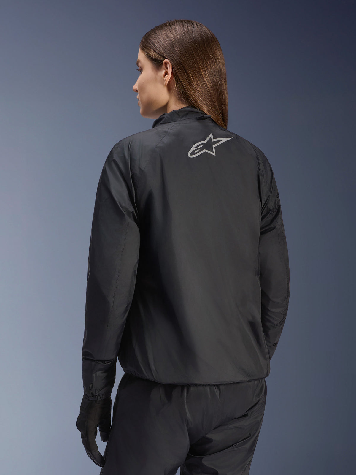 Alpinestars Stella Andes Air Drystar® Jacket, Women's Motorcycle Jacket, Black, rear view showing silver star logo, paired with black pants and gloves, lightweight waterproof touring gear