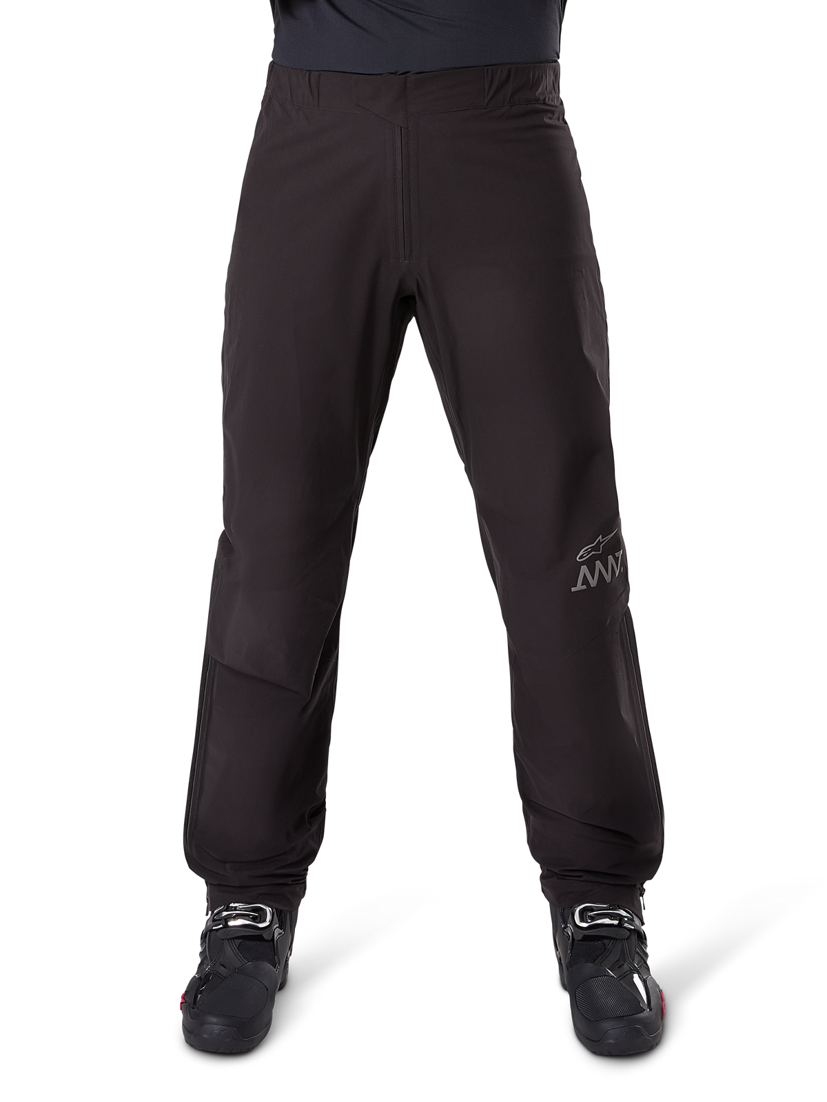 Alpinestars AMT-8 Stretch Drystar® XF Pant Liner, Black, front view worn with black motorcycle boots, featuring grey star logo and AMT branding on the leg, versatile waterproof and windproof motorcycle apparel