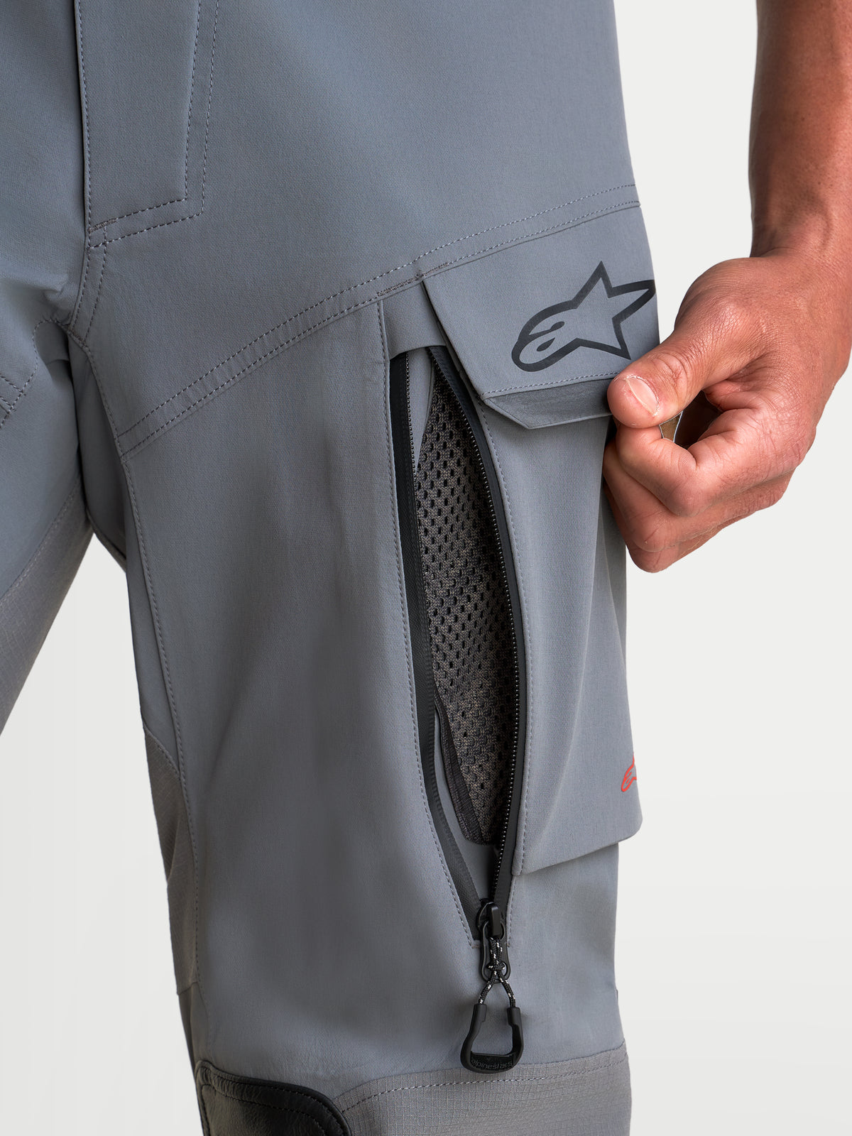 Alpinestars Maxdura Drystar XF Laminated Pants, Men's adventure motorcycle pants in Dark Gray and Black, close-up view of the zippered thigh vent and water-resistant cargo pocket with A-star logo, CE AA certified