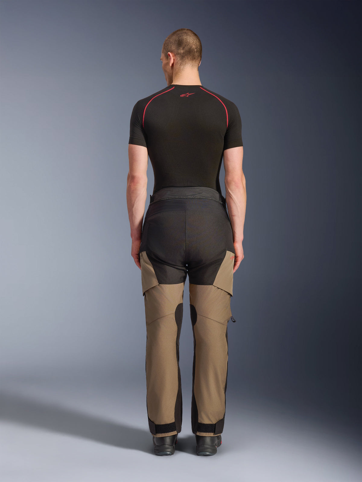 Alpinestars Andes V4 Drystar® Pants, Adventure Motorcycle Pants, Walnut and Black, back view shown on a model, featuring reinforced panels and a durable textile construction for all-weather riding.