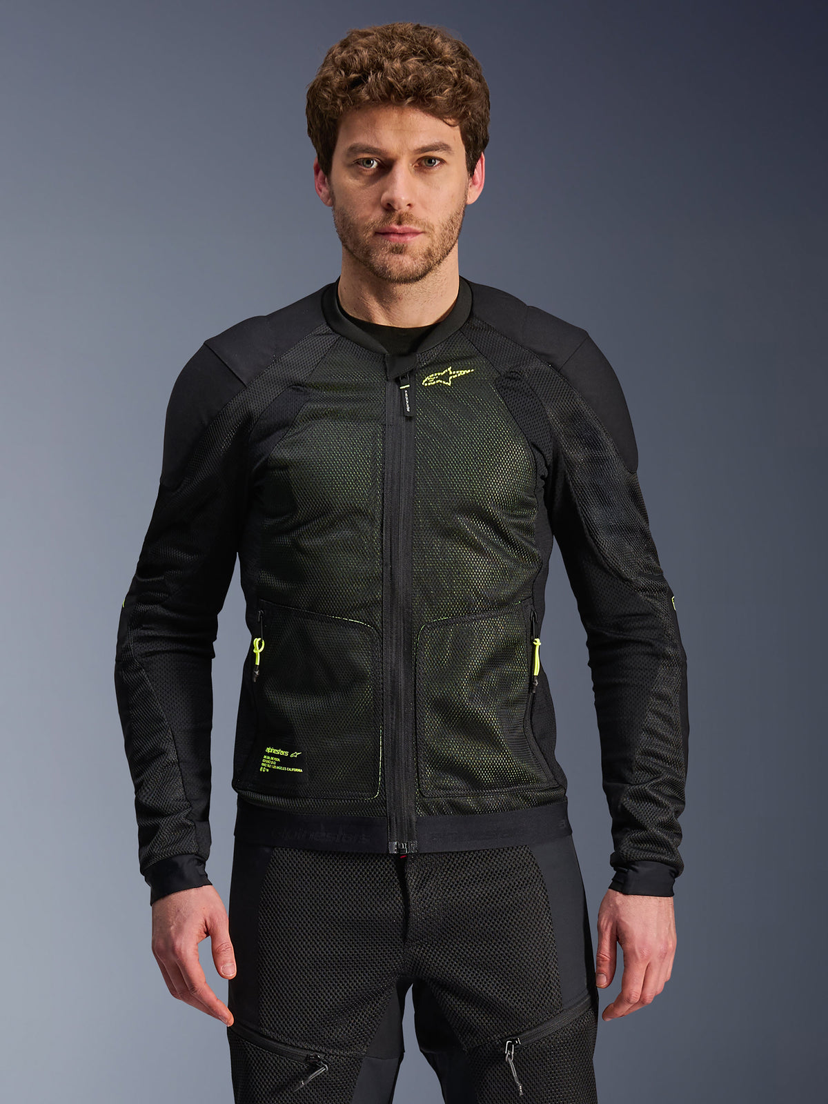 Alpinestars Troop-Air Jacket, Black and Yellow Fluo, worn by male model, featuring lightweight mesh construction, neon yellow zippers and branding, technical ventilated motorcycle jacket for urban riding