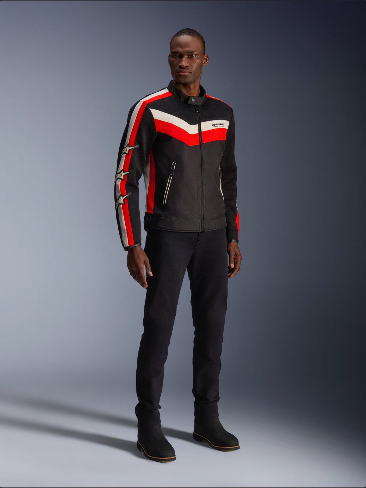 Alpinestars T-Dyno Air Jacket, Black Bright Red Ecru, men's textile motorcycle jacket with 3D mesh panels, featuring red and white chevron stripes on the chest and star logos on the sleeves, worn by a model with black pants and boots.