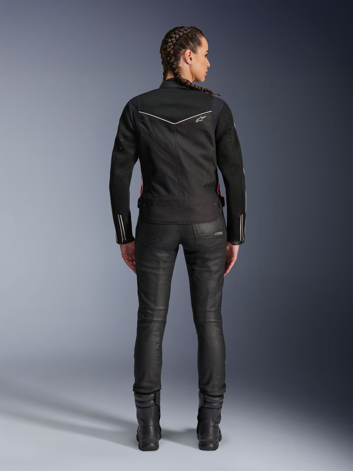 Alpinestars Stella T-Dyno Air Jacket, Rear view, Black woman's motorcycle jacket with white piping and small star logo, worn with black technical pants and riding boots, sleek biker fit for urban road riding