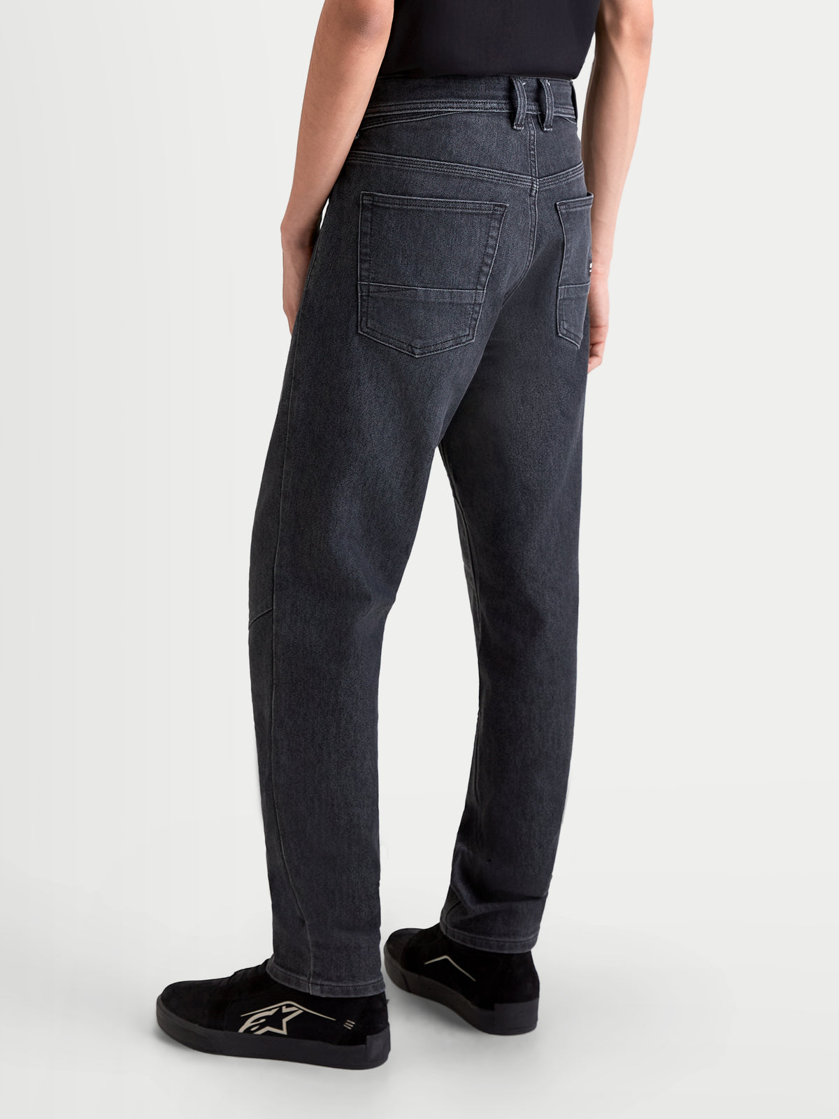 Alpinestars Flex-AST 7 Denim Pants Short, men's urban motorcycle riding jeans in faded black, rear view showing single-layer technical denim construction and five-pocket layout worn by a model.