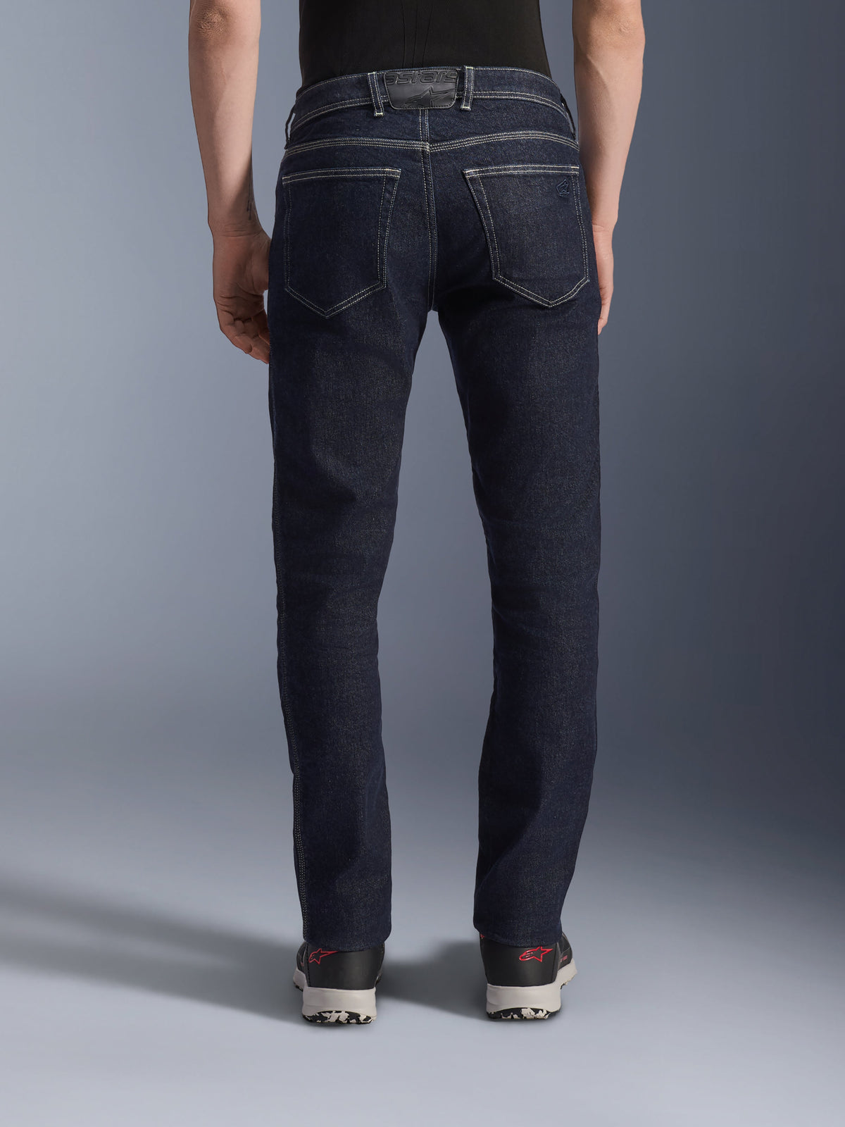 Alpinestars Copper V3 Denim Pants, Motorcycle Riding Jeans in Rinse Blue, back view showing regular straight leg fit, dual rear pockets with contrast white stitching, dark indigo stretch denim with logo patch on the waistband.