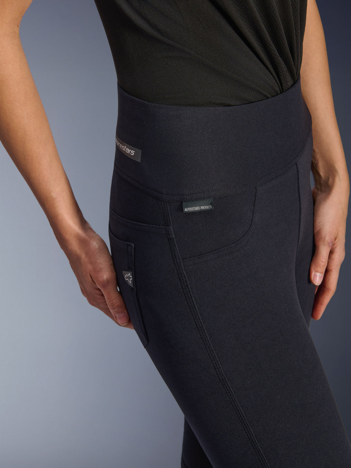 Alpinestars Woman Stella Flex-AST Leggings, Black high-waisted motorcycle pants, close-up of the hip area featuring the jacquard label, triple top-stitched side seams, and denim-inspired pocket detail, urban riding apparel for women