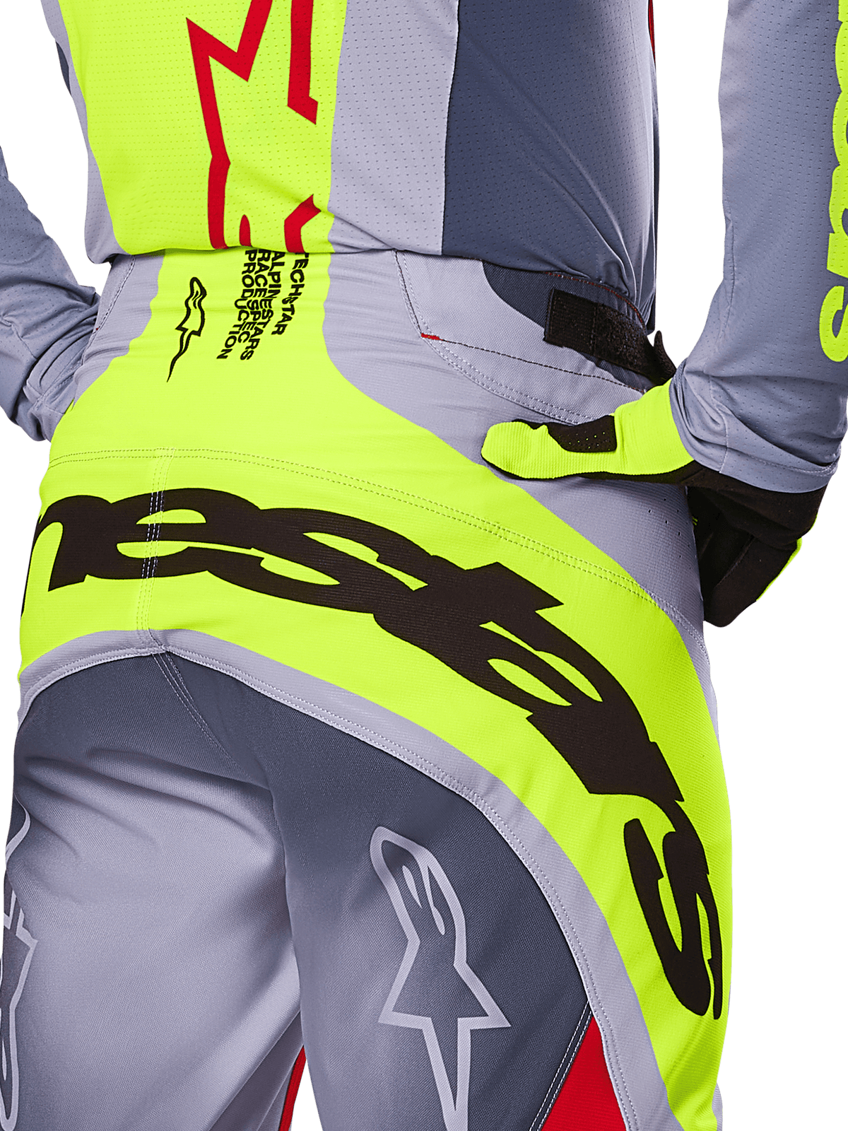 Alpinestars 2025 Techstar Melt Pants, close-up of the rear seat and waist area, gray and neon yellow design with large black branding, featuring star logos and race-spec text, high-performance motocross gear
