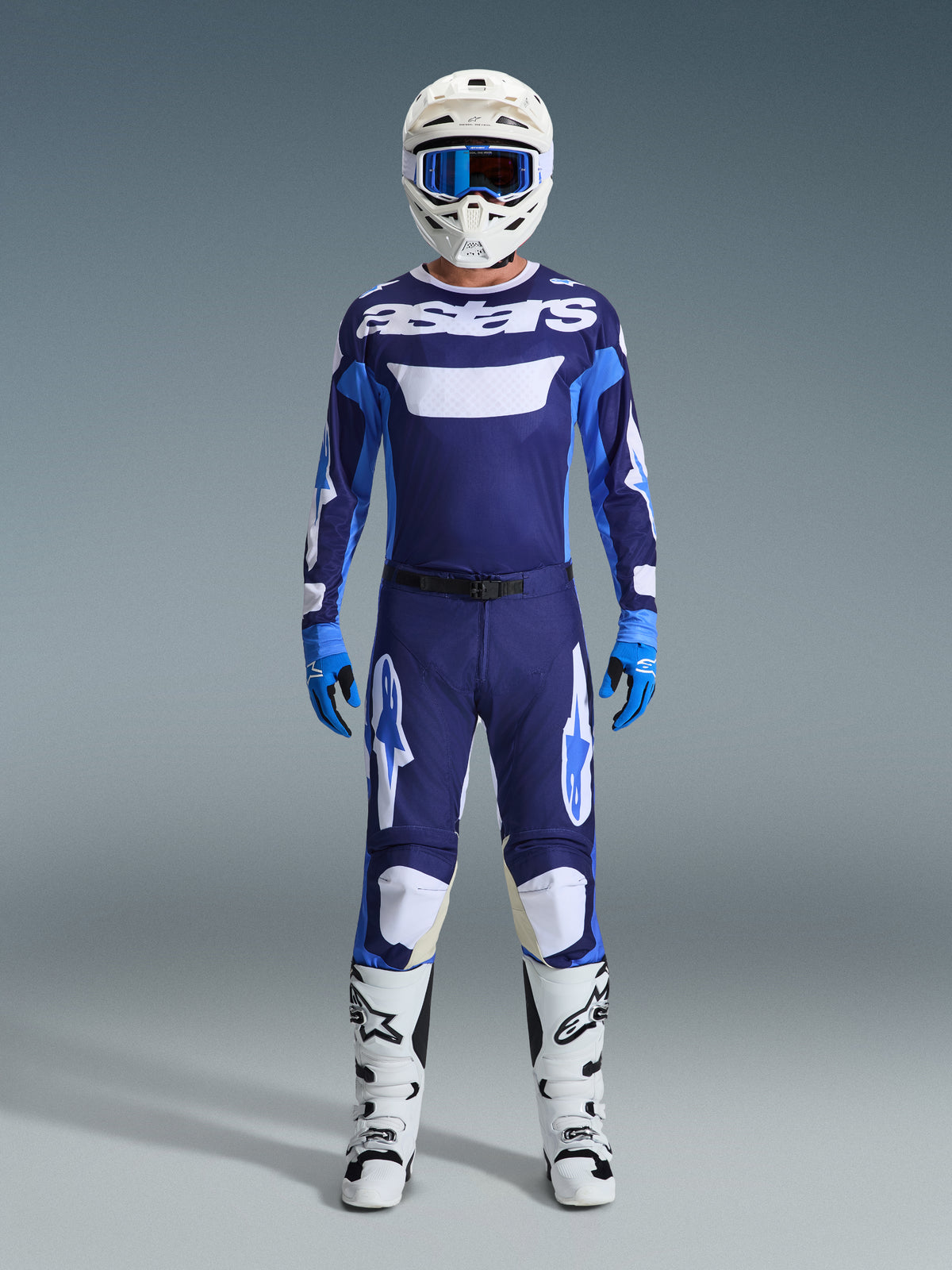 Alpinestars 2026 Racer Riway Gear Set, full motocross racing gear, Navy Blue and Light Blue jersey with white 'astars' text, matching pants with white accents, white helmet with blue goggles, and white off-road boots.