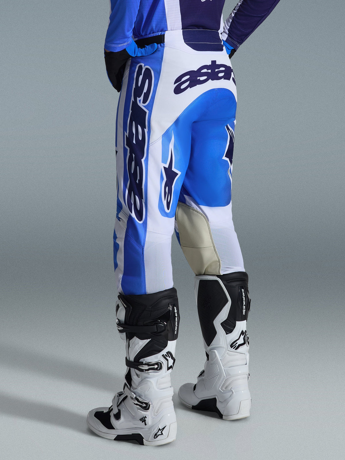 Alpinestars 2026 Racer Air Portl Pants, Motocross Pants, Ucla Blue White, rear view, bold blue and white design with large branding on the seat and side, reinforced goat leather inner knees, worn with white and black motocross boots for off-road performance.