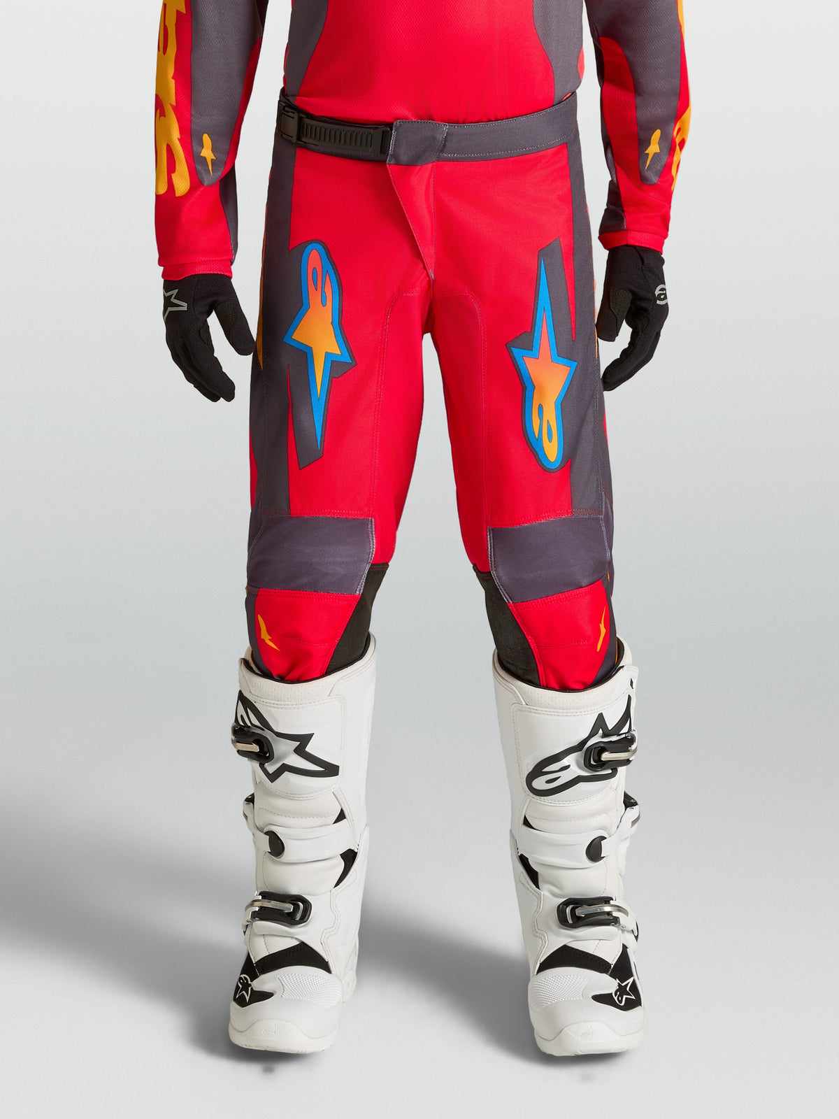 Alpinestars Youth Fluid Hunt Pants, red and gray motocross pants for off-road riding with ergonomic polyfabric design.