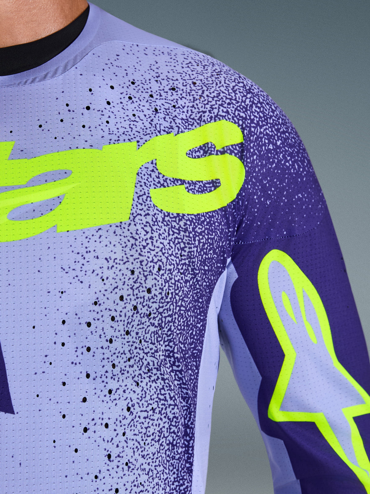 Alpinestars 2026 Supertech Scenz Jersey, Motocross Jersey, Purple and Yellow Fluo, close-up view showing perforated stretch mesh material and bright yellow Alpinestars branding on the chest and sleeve