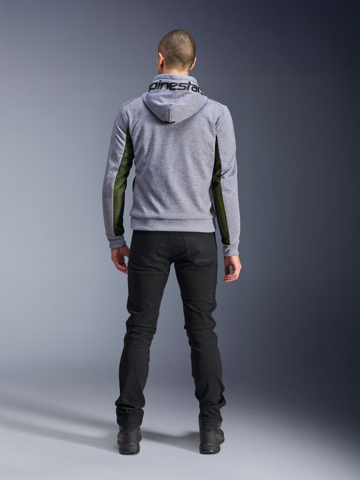 Alpinestars Chrome Air Sport Hoodie, Gray Heather Black, back view of motorcycle riding hoodie featuring green high-flow mesh panels on the sides and sleeves, tech fleece construction with Alpinestars branding on the hood, worn with black pants