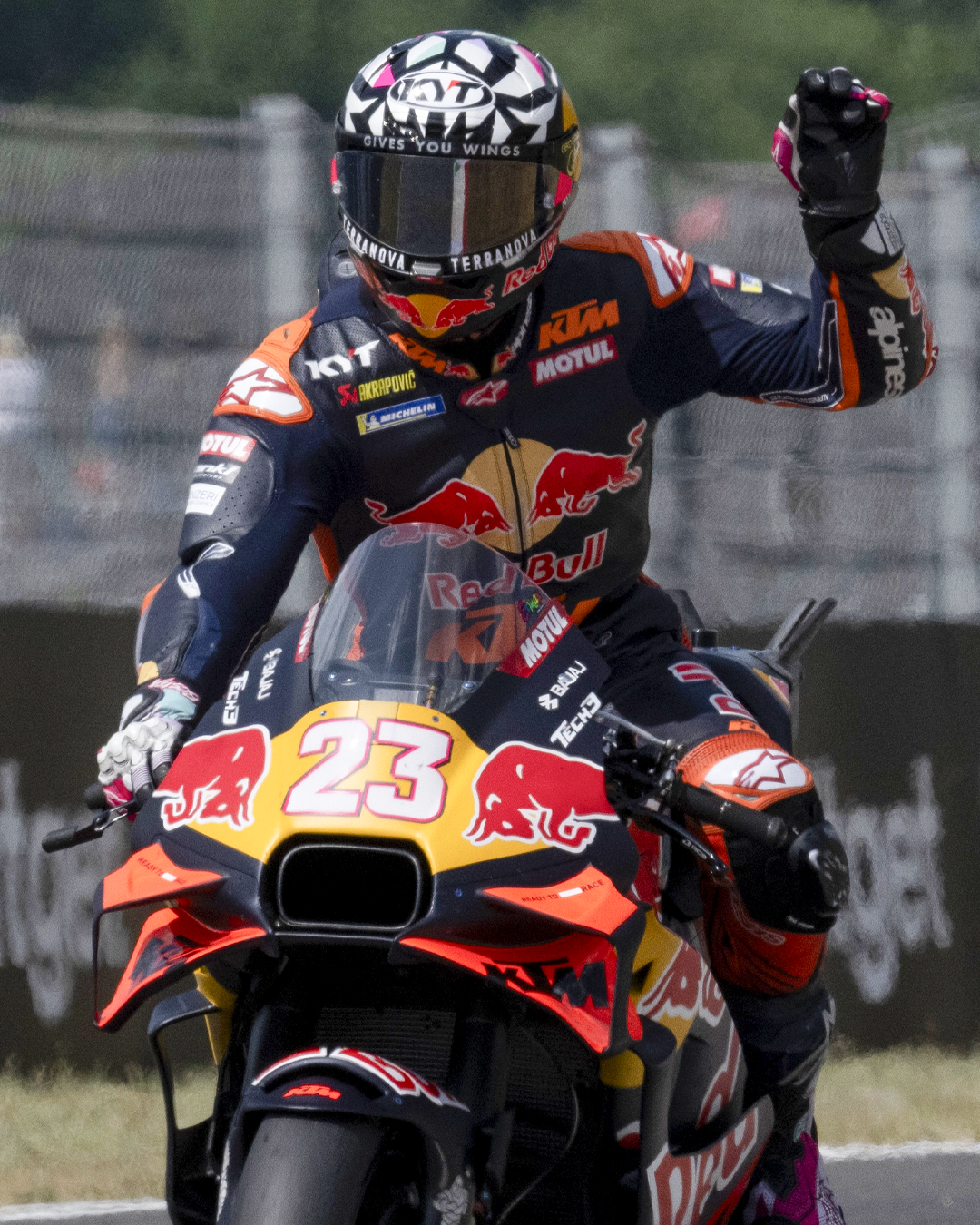 Bastianini raising his arm in a victory sign