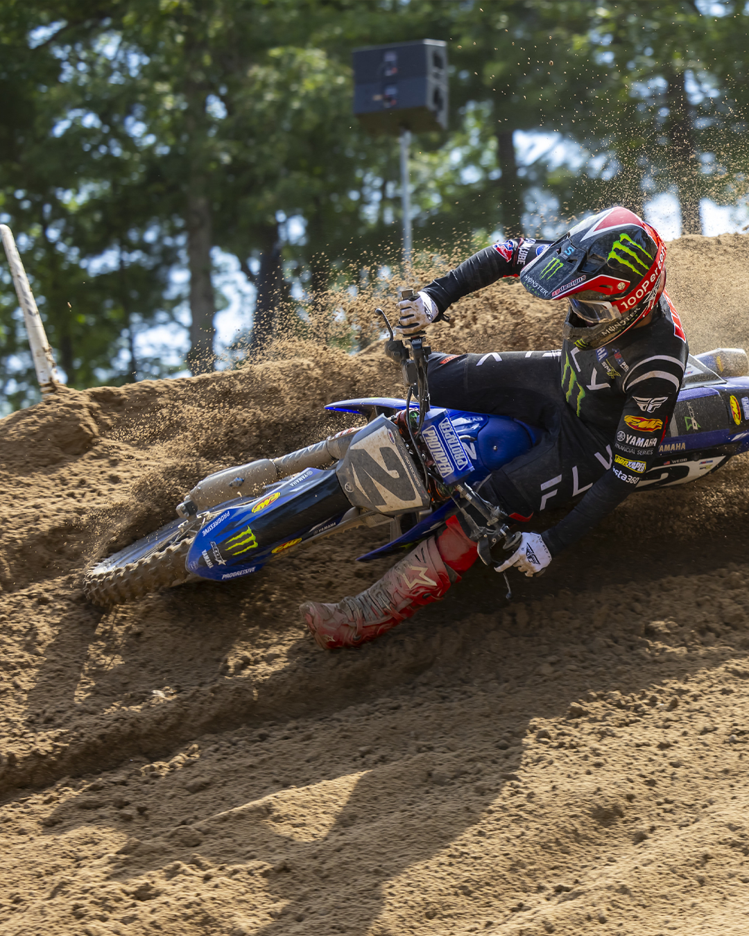 Cooper Webb in action on a dirt track with a Monster Energy Yamaha bike.