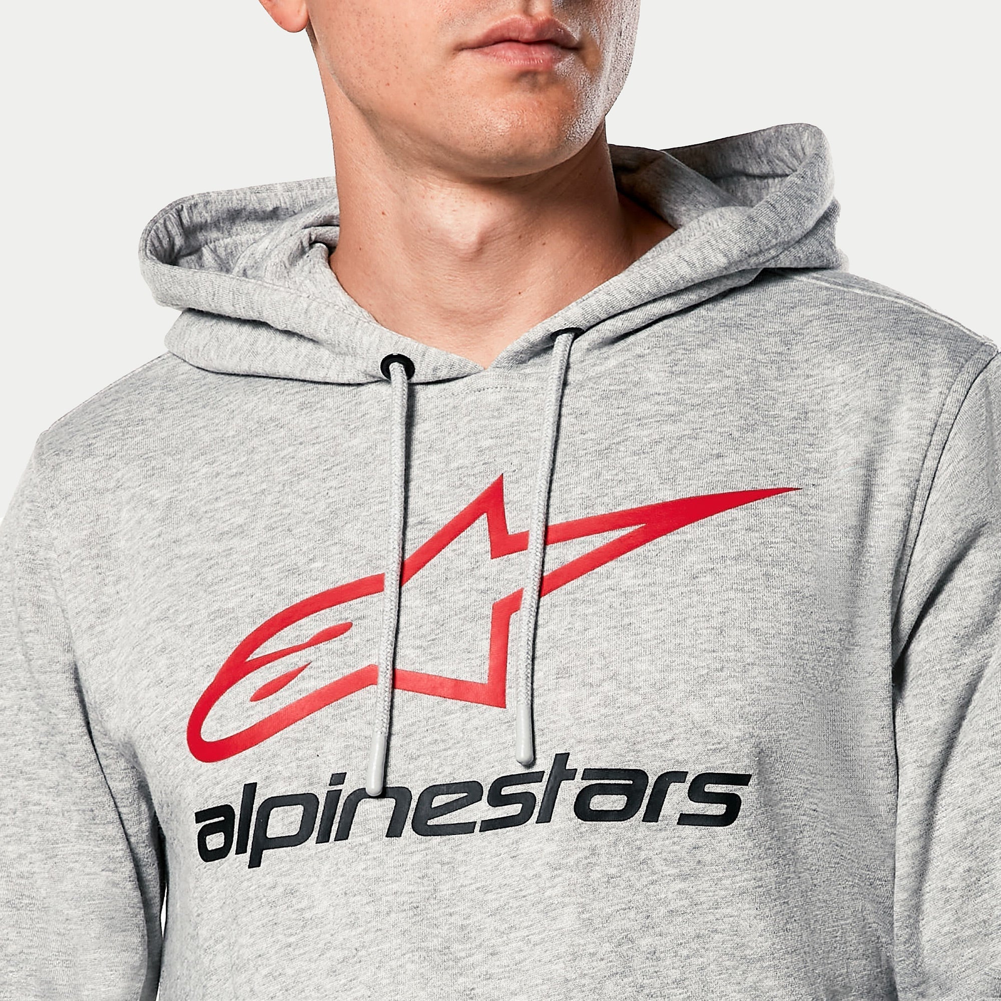 Alpinestars Always V3 Hoodie, Grey Heather, close-up of chest featuring red star logo and black Alpinestars text, jersey-lined hood with grey drawcords, casual motorsport streetwear