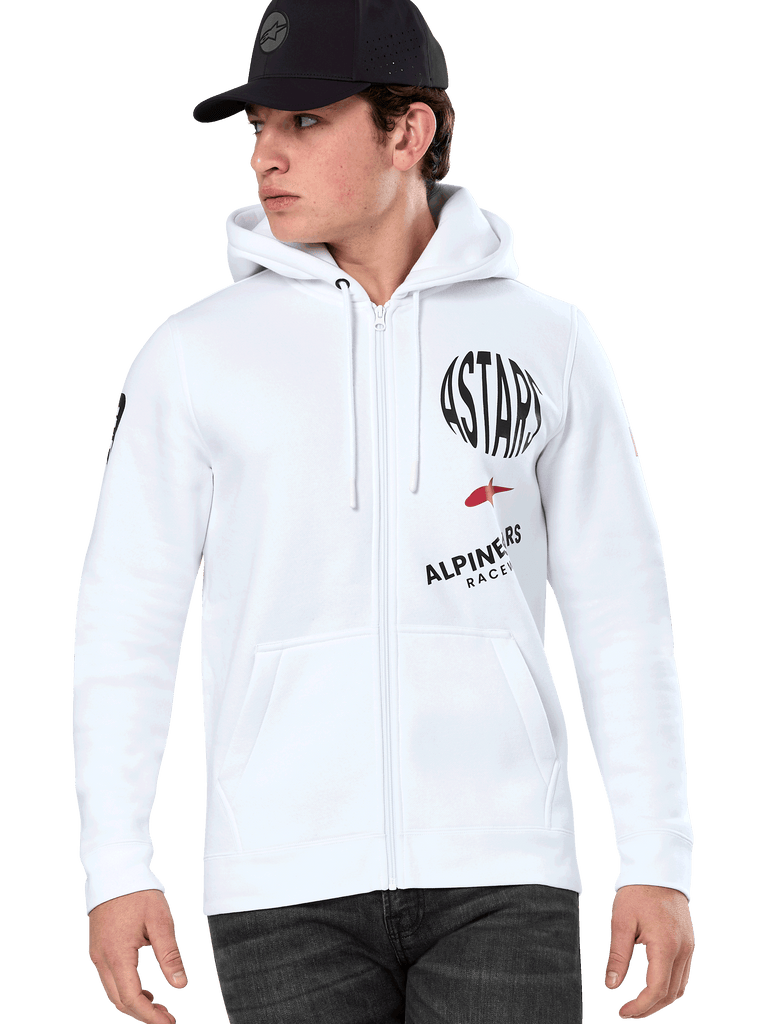 Alpinestars Variegate Hoodie, White Zip-Up Hoodie with black and red ASTARS racing graphics, worn by a model with a black cap and dark jeans, casual motorsport streetwear featuring a kangaroo pocket and drawstring hood