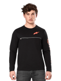 Alpinestars Committed CSF Long Sleeve Tee, Black, male model wearing casual long-sleeve shirt with orange Astars logo on chest, white line detail, and bold orange sleeve graphics, paired with dark grey jeans