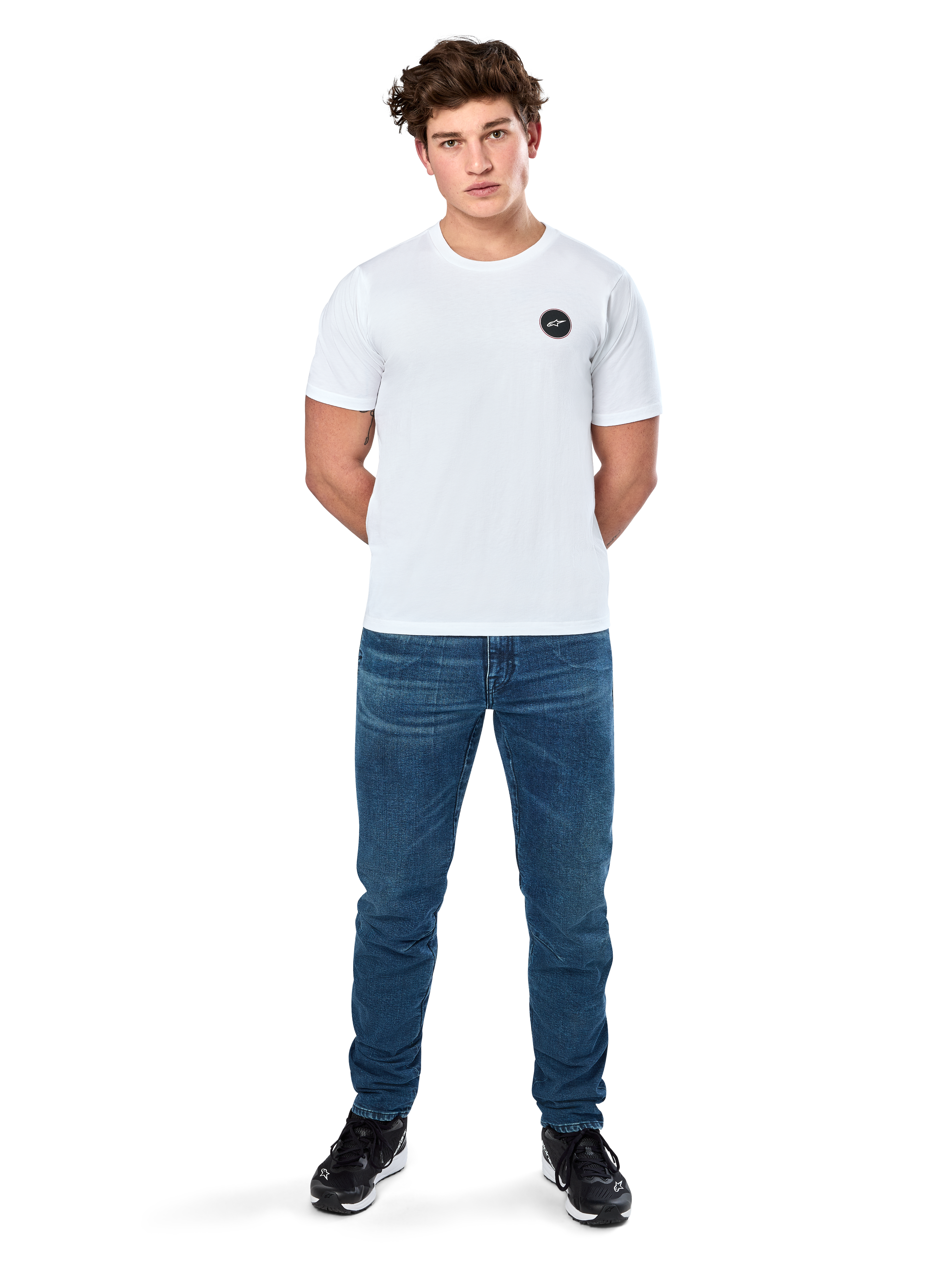 Alpinestars Dot Carbon Csf Tee, Short Sleeve T-Shirt, White, Circular Astars Logo with carbon fiber look, Casual Motorsport Streetwear, worn by a male model with blue jeans and black sneakers