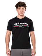 Alpinestars Prevail CSF Tee, Black Short Sleeve T-Shirt worn by a model, featuring white branding with a tri-color stripe and "PREMIUM RACEWEAR" graphic, casual motorsport streetwear
