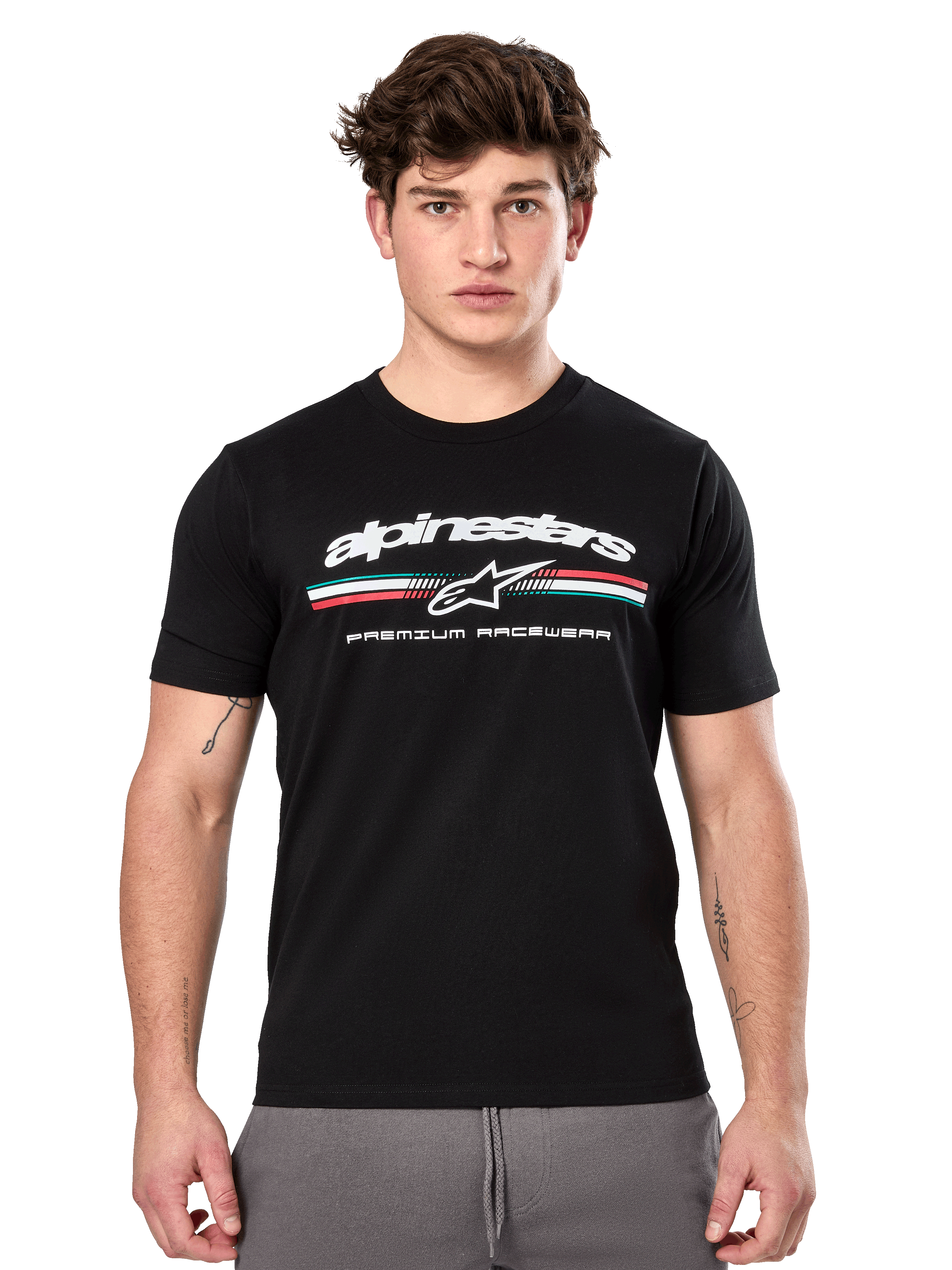 Alpinestars Prevail CSF Tee, Black Short Sleeve T-Shirt worn by a model, featuring white branding with a tri-color stripe and "PREMIUM RACEWEAR" graphic, casual motorsport streetwear