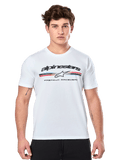 Alpinestars Prevail CSF Tee, White Short Sleeve T-Shirt, featuring a front paddock-style tri-color stripe logo with red and blue accents, black Alpinestars branding, and 'Premium Racewear' text, worn by a male model, casual motorsport apparel