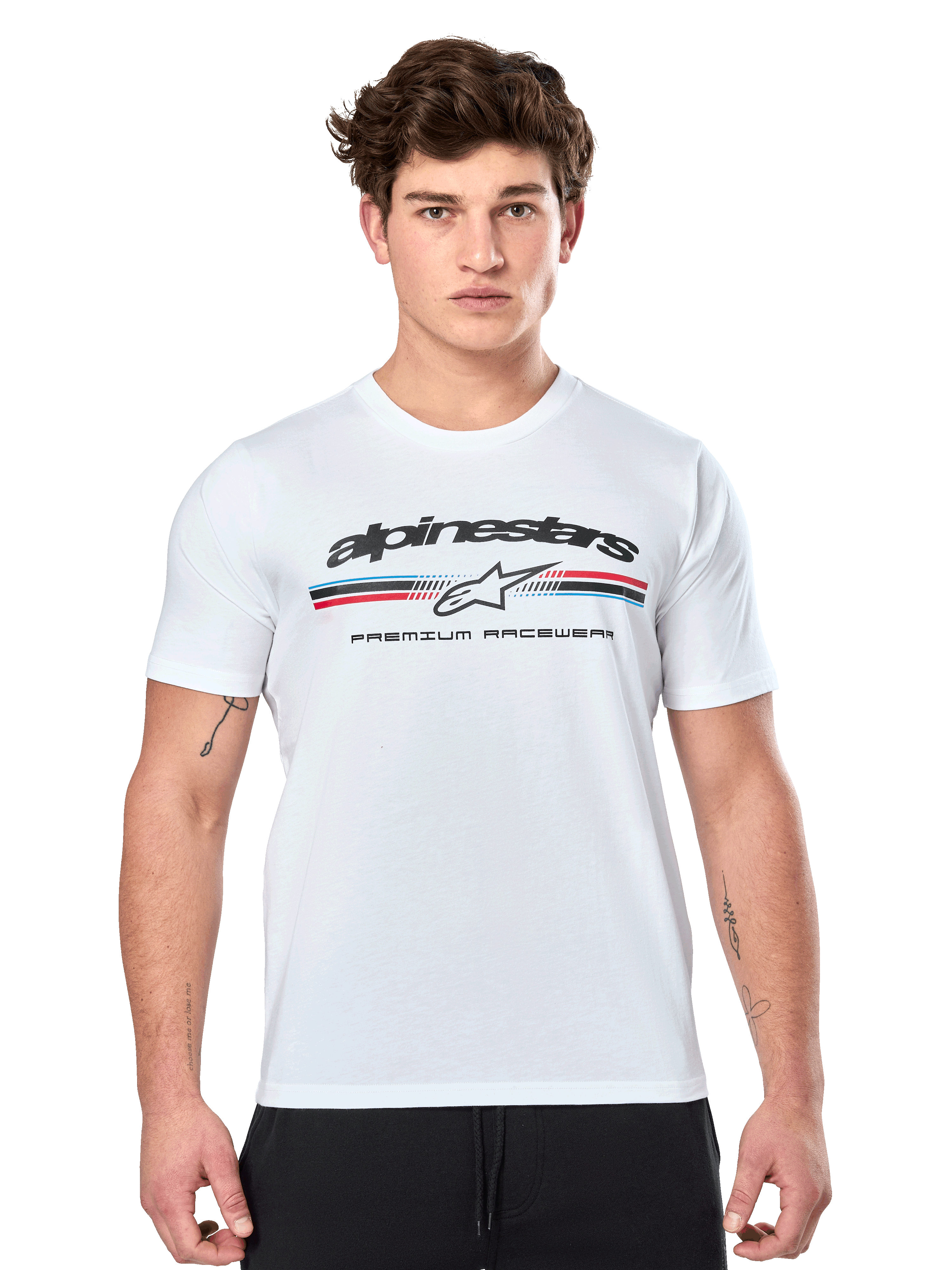 Alpinestars Prevail CSF Tee, White Short Sleeve T-Shirt, featuring a front paddock-style tri-color stripe logo with red and blue accents, black Alpinestars branding, and 'Premium Racewear' text, worn by a male model, casual motorsport apparel