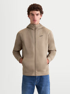 Alpinestars Cypher Hoodie, Men's Full-Zip Sportswear Hoodie, Putty Beige, featuring a high-neck hood, tri-blend double-face fleece fabric, and a black Alpinestars chest logo, on-model front view with hands in pockets.