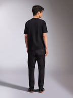 Alpinestars Noka CSF Tee, Short Sleeve T-Shirt, Black, back view of model wearing the tee with black pants and sneakers, casual motorsport streetwear style