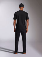Alpinestars Ellipsoid CSF Tee, Short Sleeve T-Shirt, Black, Back view worn by model with black cap and pants, casual motorsport-inspired streetwear