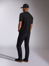 Alpinestars Plate CSF Tee, Short Sleeve T-Shirt, Black, back view on model wearing black pants and a baseball cap, casual motorsport streetwear