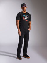 Alpinestars Plate CSF Tee, Short Sleeve T-Shirt, Black, colorful front MX plate graphic with star logo, worn by model with black logo cap and pants, casual motorsport-inspired streetwear