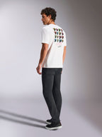 Alpinestars Pop Helmet CSF Tee, Short Sleeve T-Shirt, White, back view on model showing colorful M10 helmet graphic art, styled with dark pants and black sneakers, casual motorsport-inspired streetwear