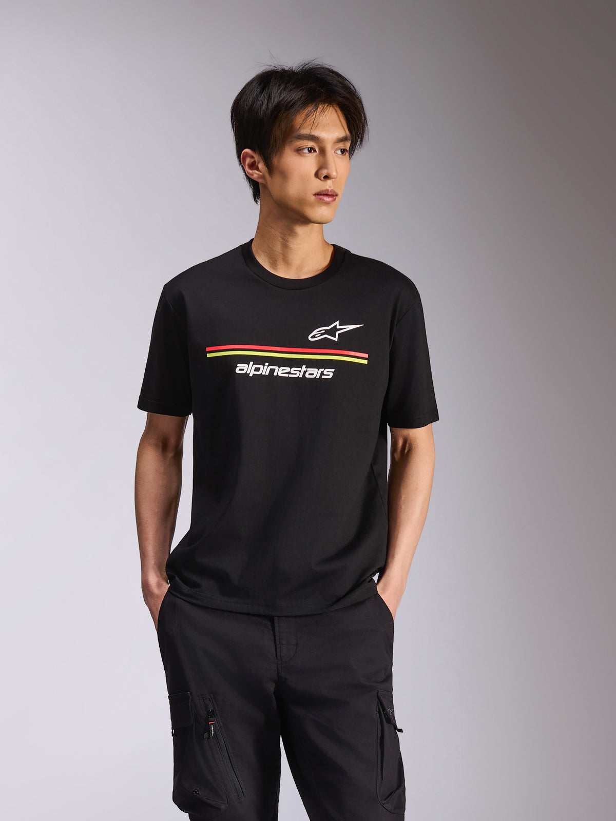 Alpinestars Lanes CSF Tee, Short Sleeve T-Shirt, Black, White Astars and Alpinestars logos with red and yellow horizontal stripes, casual motorsport streetwear