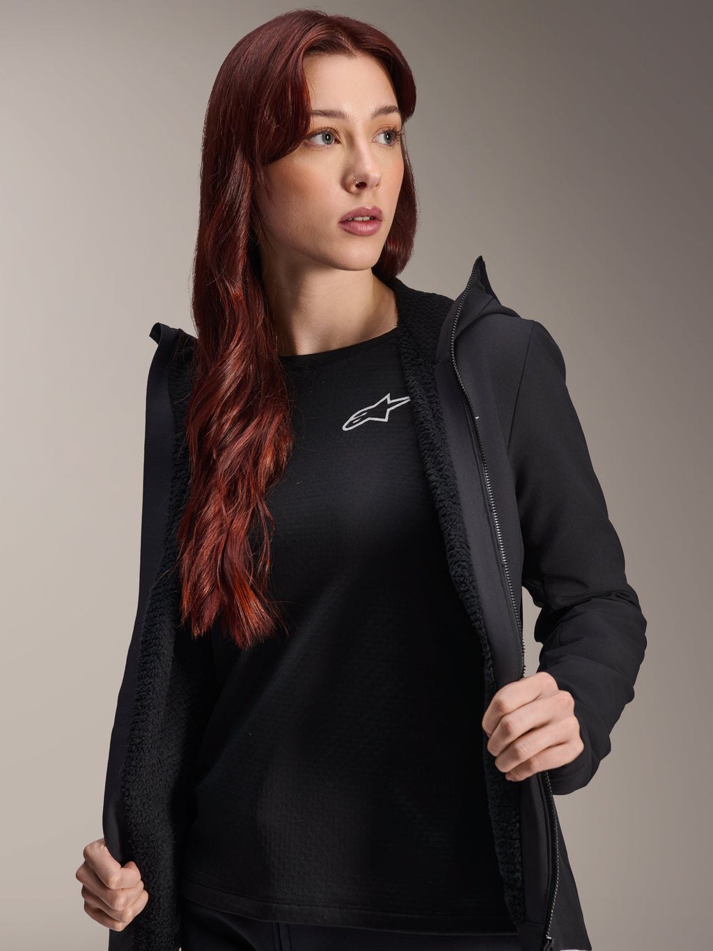 Alpinestars Stella A-Dura Thermal Jacket, Women's Black Cycling Jacket, shown open with textured fleece lining and zippered front, worn over a black t-shirt with the Alpinestars logo, lightweight and insulated for cold-weather riding