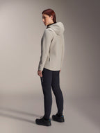Alpinestars Stella A-Dura Thermal Jacket in Titanium Gray, three-quarter rear view of a woman wearing the insulated hooded cycling jacket with black MTB pants, studio shot showing the regular fit and pocket detail.