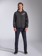 Alpinestars Speeder Chromium Windbreak Jacket, Black with White Astars Logo, worn by model with dark blue jeans and black sneakers, featuring a hooded design and front zipper, casual motorsport-inspired streetwear