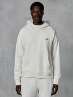Alpinestars Essentials Ageless Hoodie, off-white, worn by male model, small black logo on chest, front pouch pocket, long sleeves, casual motorsport-inspired streetwear