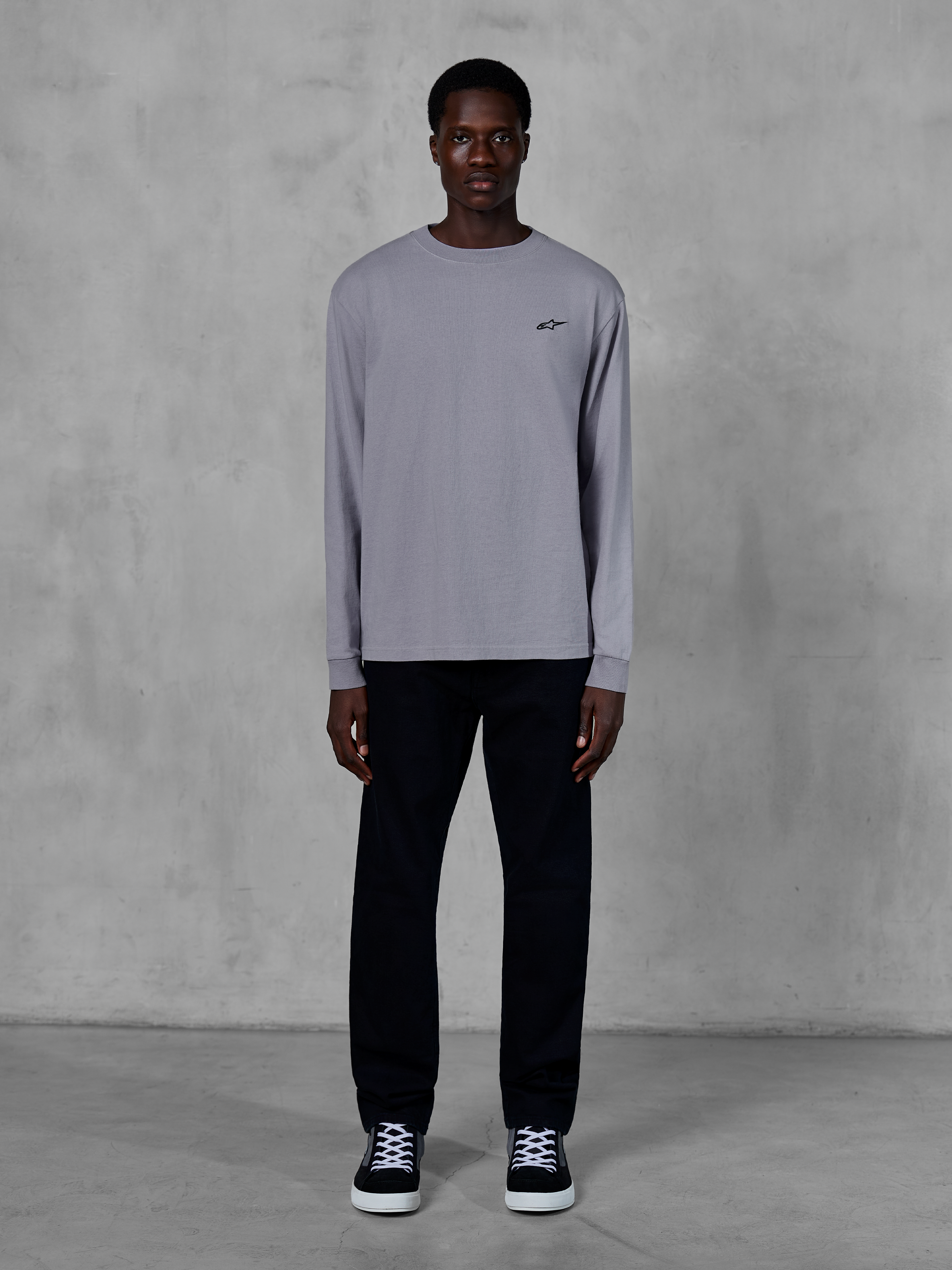 Alpinestars Essentials Ageless LS Tee, Long Sleeve T-Shirt, Silver, small black Alpinestars logo on the chest, organic cotton jersey with stone wash finish, worn by a model with black pants and sneakers, casual streetwear