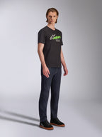 Alpinestars Entitled CSF Tee, Short Sleeve T-Shirt, Black, White and Green graphic with 'Racing Ahead' text, worn with dark jeans and black sneakers, Casual Motorsport Streetwear