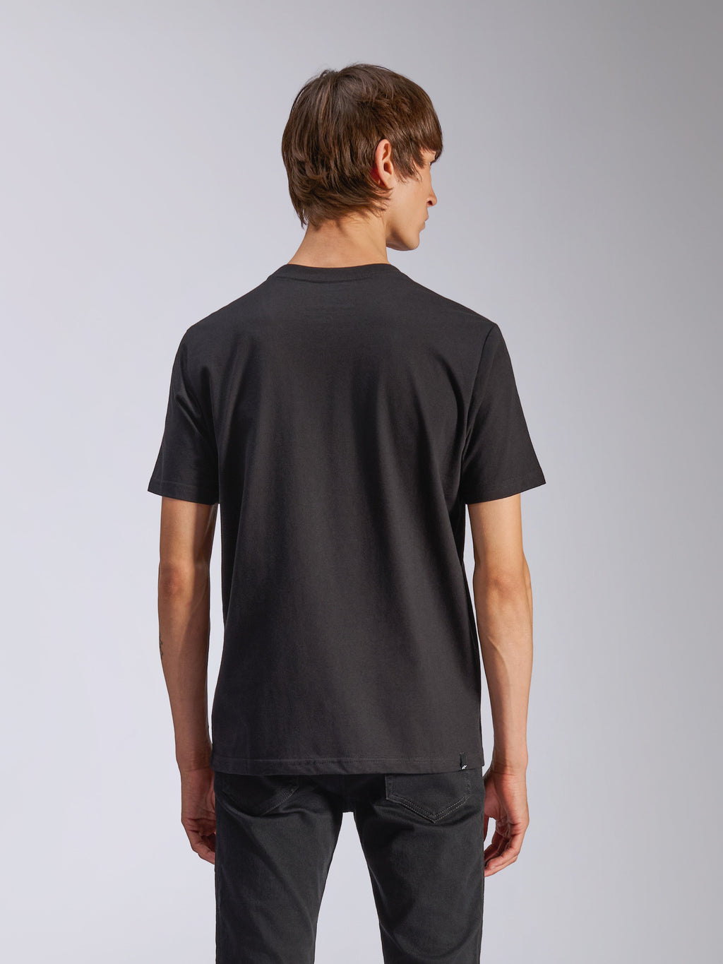 Alpinestars Harken CSF Tee, Short Sleeve T-Shirt, Black, back view of model wearing casual motorsport-inspired streetwear, simple black design, short sleeves, paired with black pants