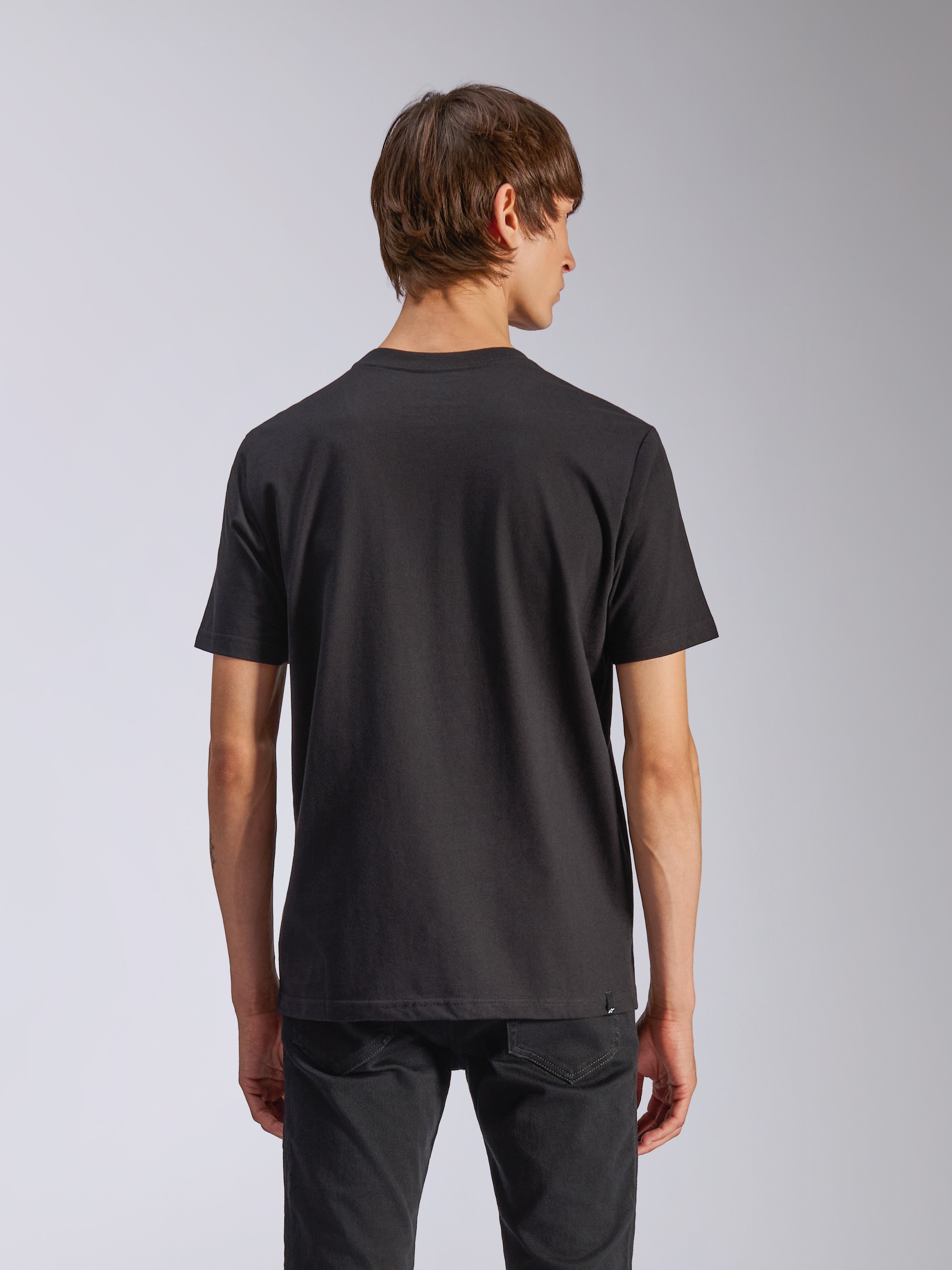 Alpinestars Harken CSF Tee, Short Sleeve T-Shirt, Black, back view of model wearing casual motorsport-inspired streetwear, simple black design, short sleeves, paired with black pants