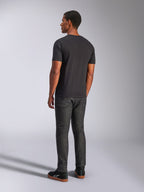 Alpinestars Heritage Patch CSF Tee, Short Sleeve T-Shirt, Black, back view on model, casual motorsport streetwear, paired with dark denim jeans and black sneakers