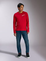 Alpinestars Trackside CSF Tee, Long Sleeve T-Shirt, Red with White Alpinestars Logo, lifestyle shot worn with blue jeans and black sneakers, casual motorsport-inspired sportswear