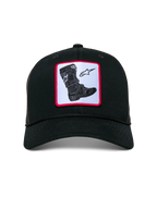 Alpinestars Booted Trucker Hat, black mesh-back cap, features a front woven patch with a Tech Boot graphic and star logo on a white background with a red border, curved bill with braided rope trim, casual motorsport streetwear