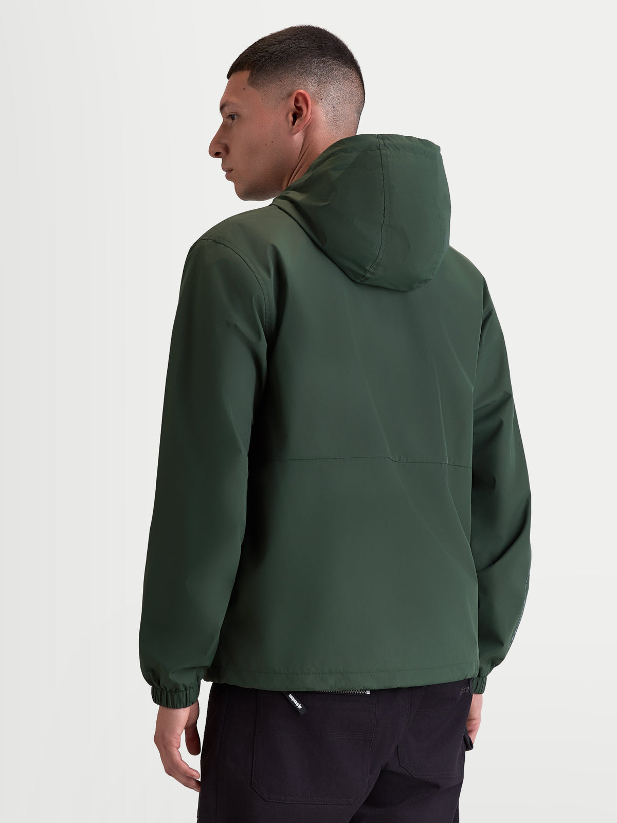 Alpinestars Speeder Resolve Windbreaker Jacket, Lightweight Sportswear Hooded Outerwear for Urban Use, Pine Green, Windproof 100% Polyester with Mesh Lining, Rear view on model highlighting the clean back design and elastic cuffs.