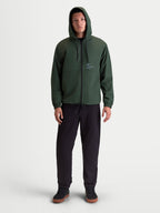 Alpinestars Speeder Resolve Windbreaker Jacket, Lightweight Sportswear Hooded Outerwear for Men and Women, Pine Green, 100% Polyester, featuring adjustable hood, reverse-coil zipper, and signature Alpinestars branding, on-model front view