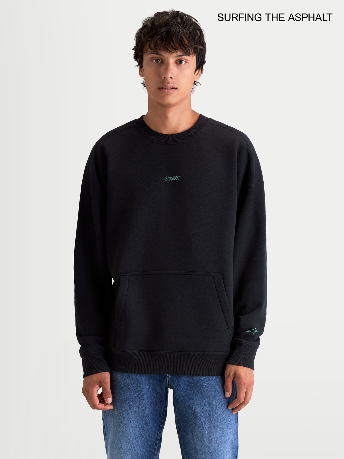 Alpinestars Guise Oversized Crew, men's sportswear fleece pullover in black, featuring a relaxed fit, crew neck, front kangaroo pocket, and embroidered logo worn by a model.