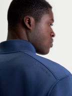 Alpinestars Apera Half-Zip Sweatshirt, Sportswear Pullover in Steel Blue, close-up back view on model showing the tonal HD Alpinestars logo print on the shoulder and premium tri-blend fleece fabric.